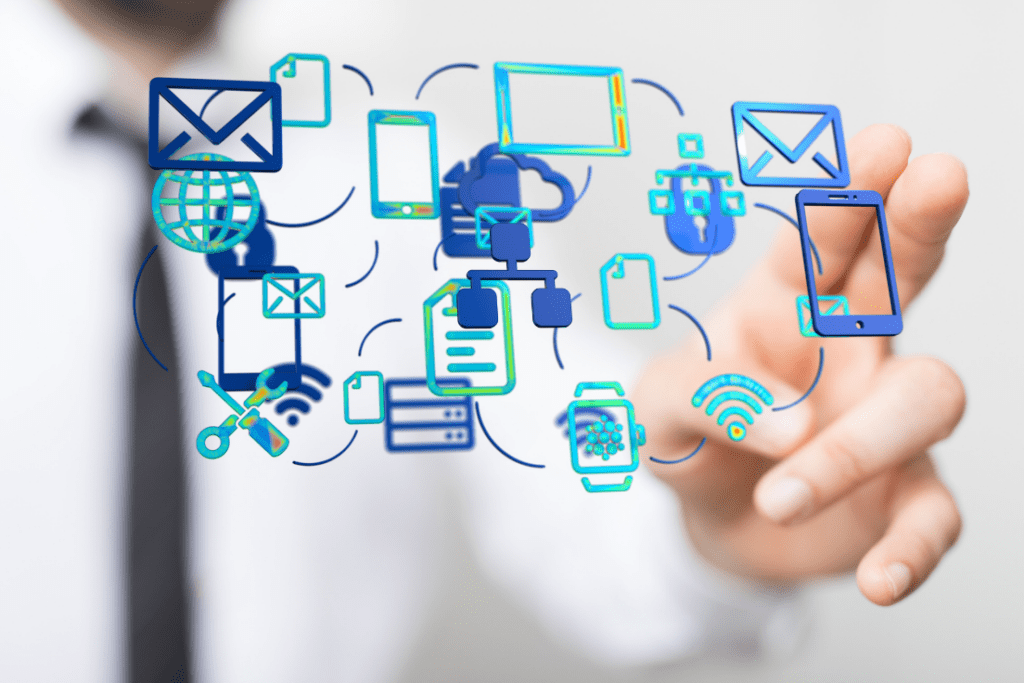 Business professional interacting with digital icons representing various technologies like mobile devices, email, cloud computing, and wireless connectivity.