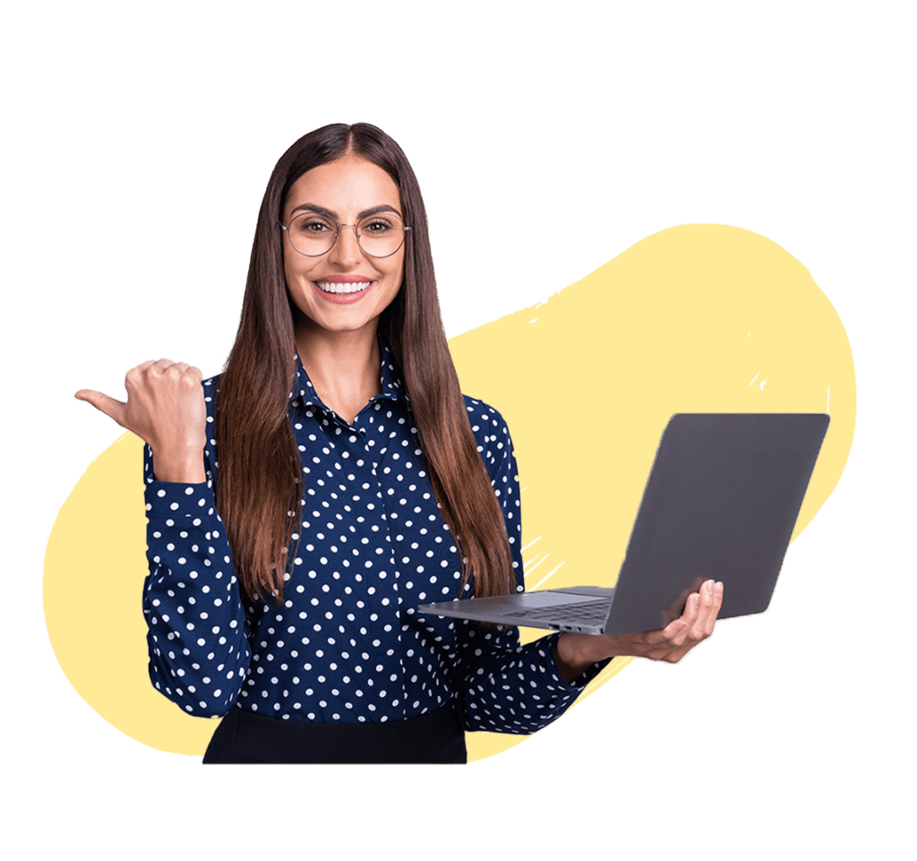A woman in a polka dot blouse holding a laptop in one hand while gesturing with her other hand, smiling at the camera. She is against a yellow background.
