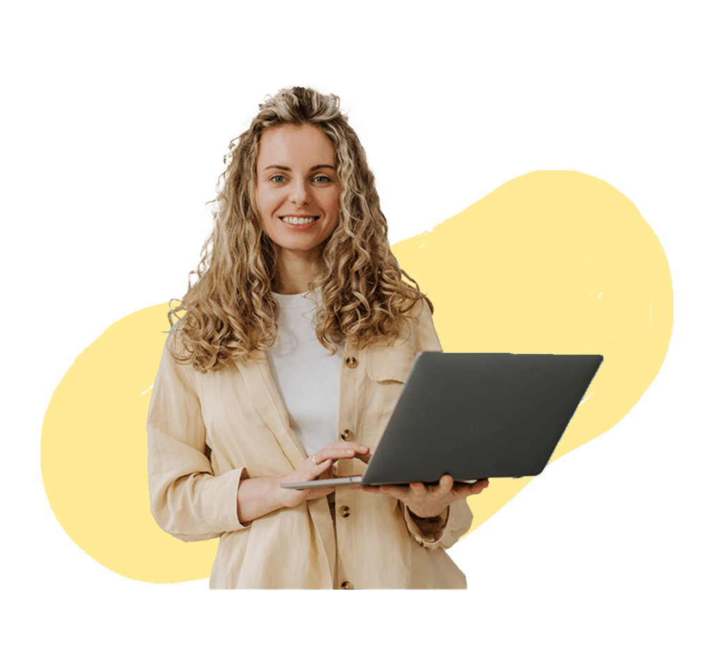 A smiling professional woman with curly hair, holding a laptop in her hands against a yellow background.