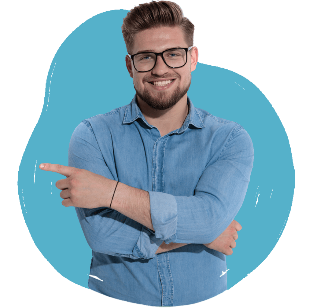 A man in a denim shirt smiling and pointing, with a light blue background.