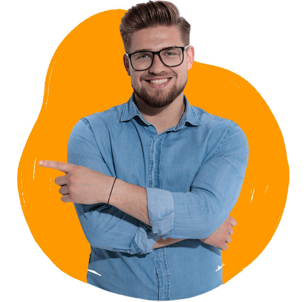 A man in a denim shirt smiling and pointing, with a orange background.