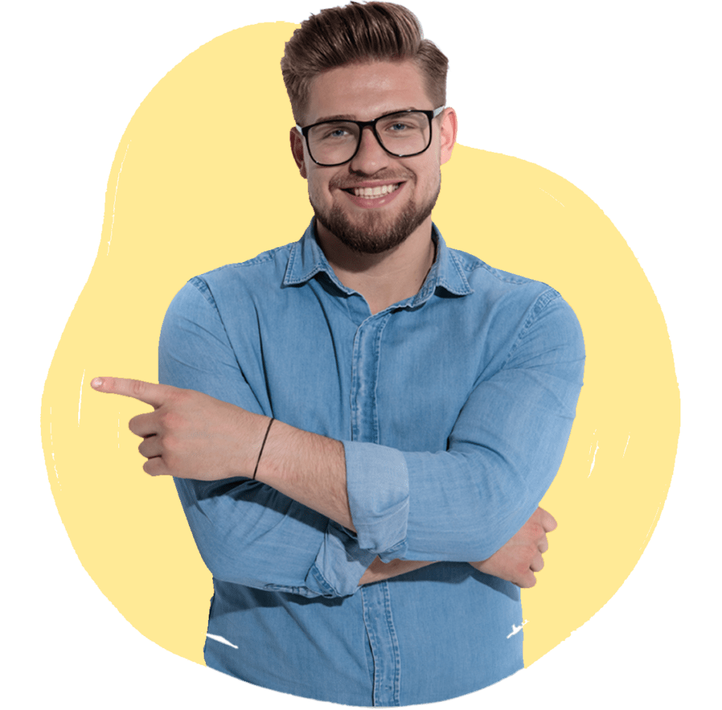 A man in a denim shirt smiling and pointing, with a yellow background.