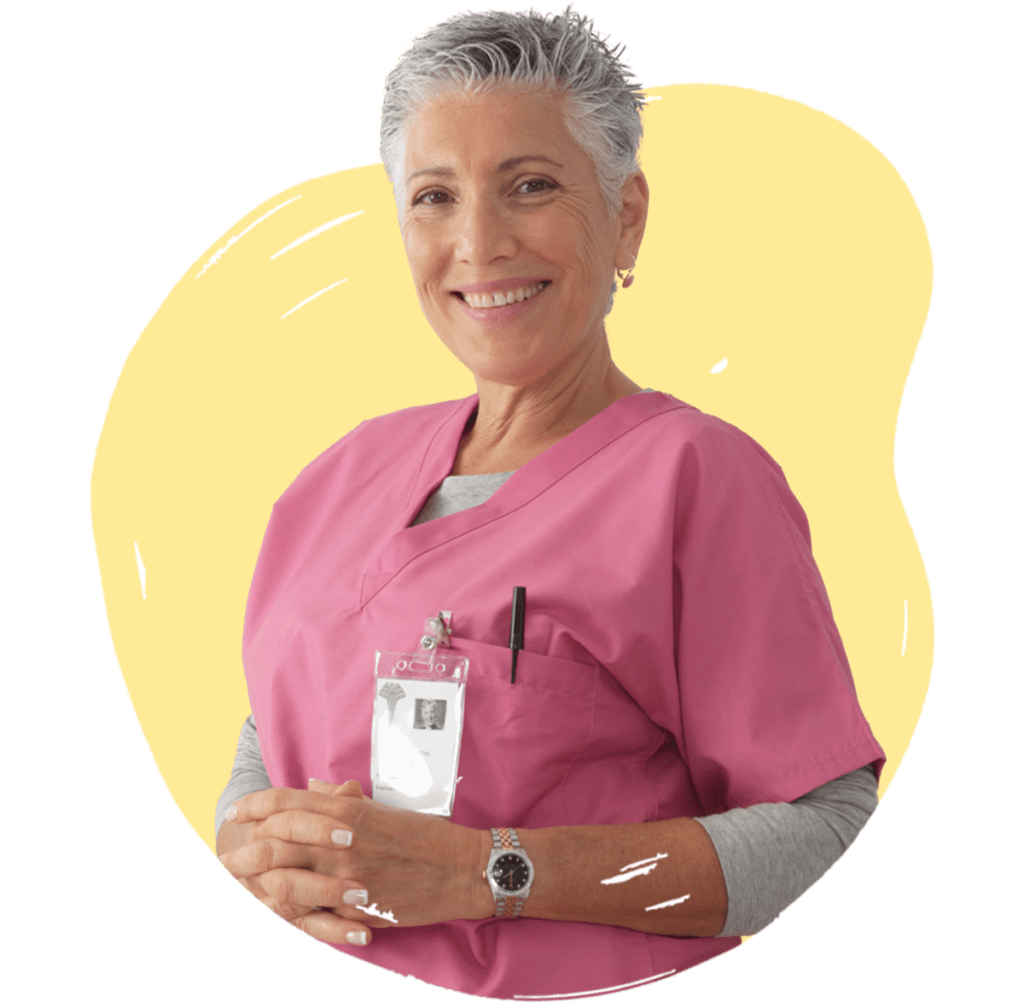 An older woman wearing pink medical scrubs, with a name badge on her chest, smiling with her arms crossed. The background is a yellow shape.