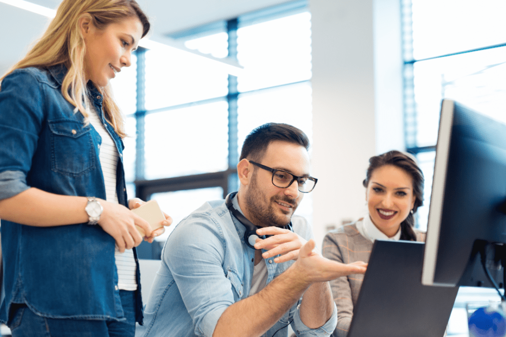 office workers looking at a computer delegated credentialing