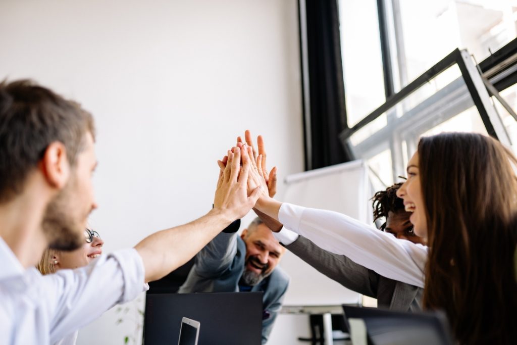 Picture of a group of people giving high fives