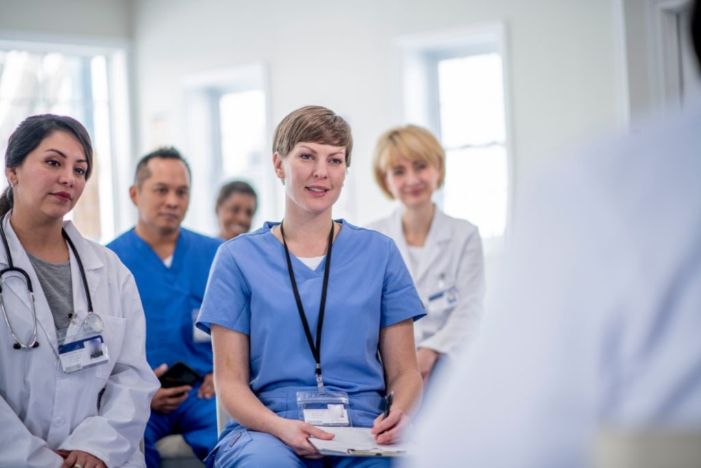 Image of providers sitting in a room listening to someone speaking