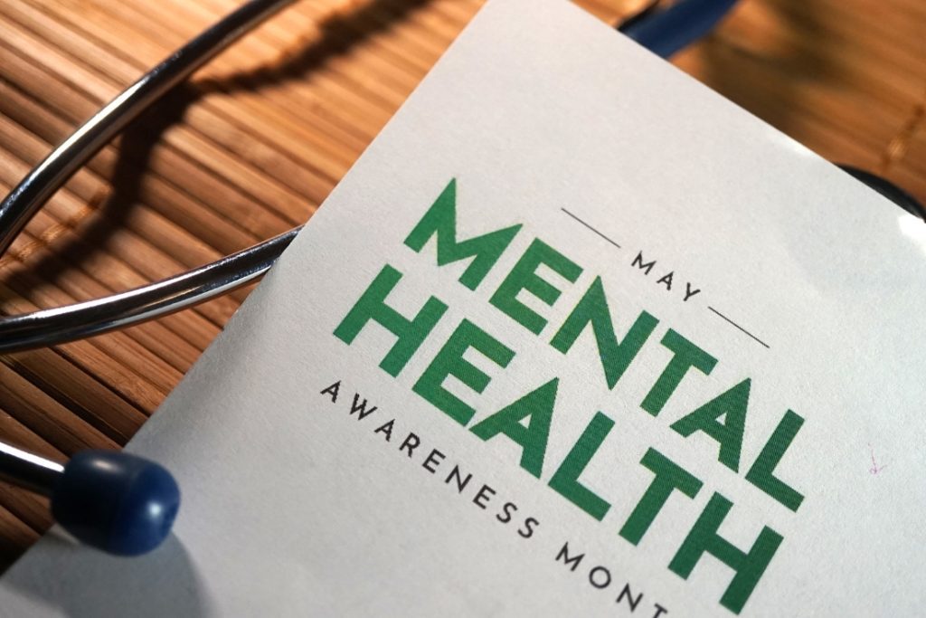 Photo of a paper that says mental health awareness month with a stethoscope