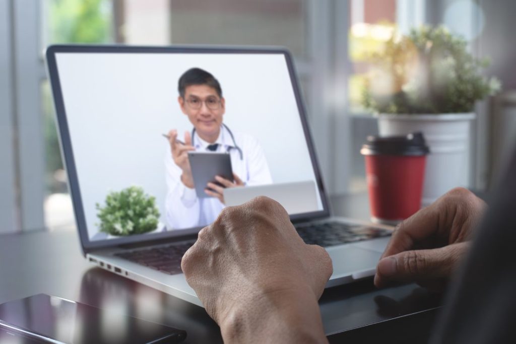 Image of a person meeting with their doctor on their laptop.